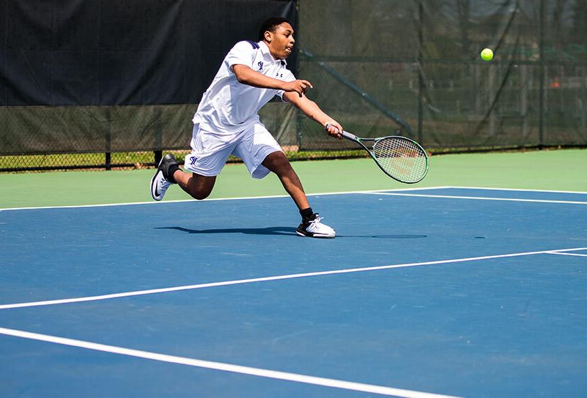 Boys Tennis player hitting the tennis ball